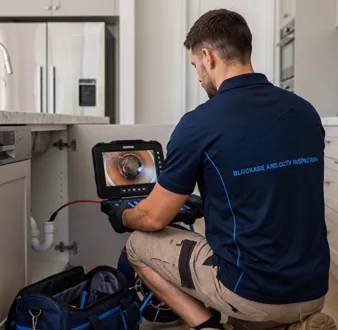 Clearing a blocked sink at a Camperdown property
